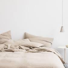 Slightly messy bedding in light beige color.