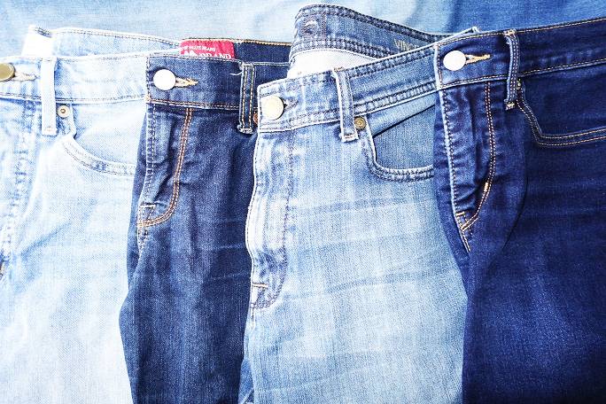 Four pairs of faded jeans in different washes